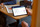 An image of a business meeting where two people are looking at a tablet device