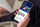 Image of a person holding a mobile phone and looking through the padel site