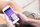 Image of a person sitting, holding their mobile phone while looking at the padel site