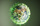 Image of a globe of the earth with many data points in green data flying out